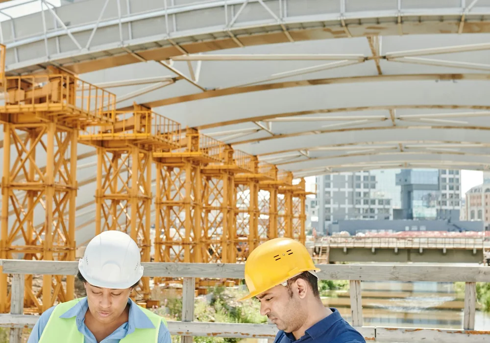 Engineer holding drawings in an office