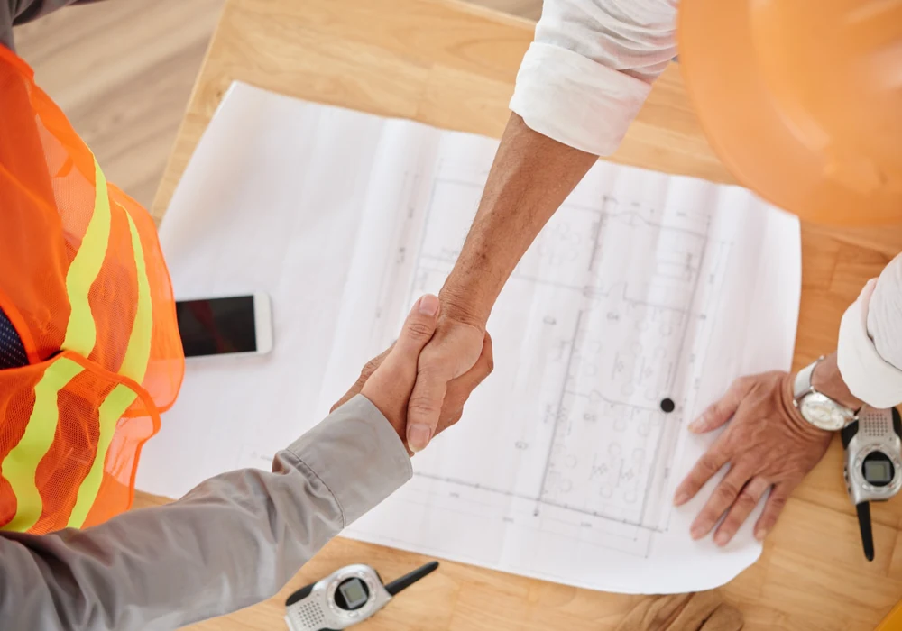 Project partners confirming collaboration over engineering drawings
