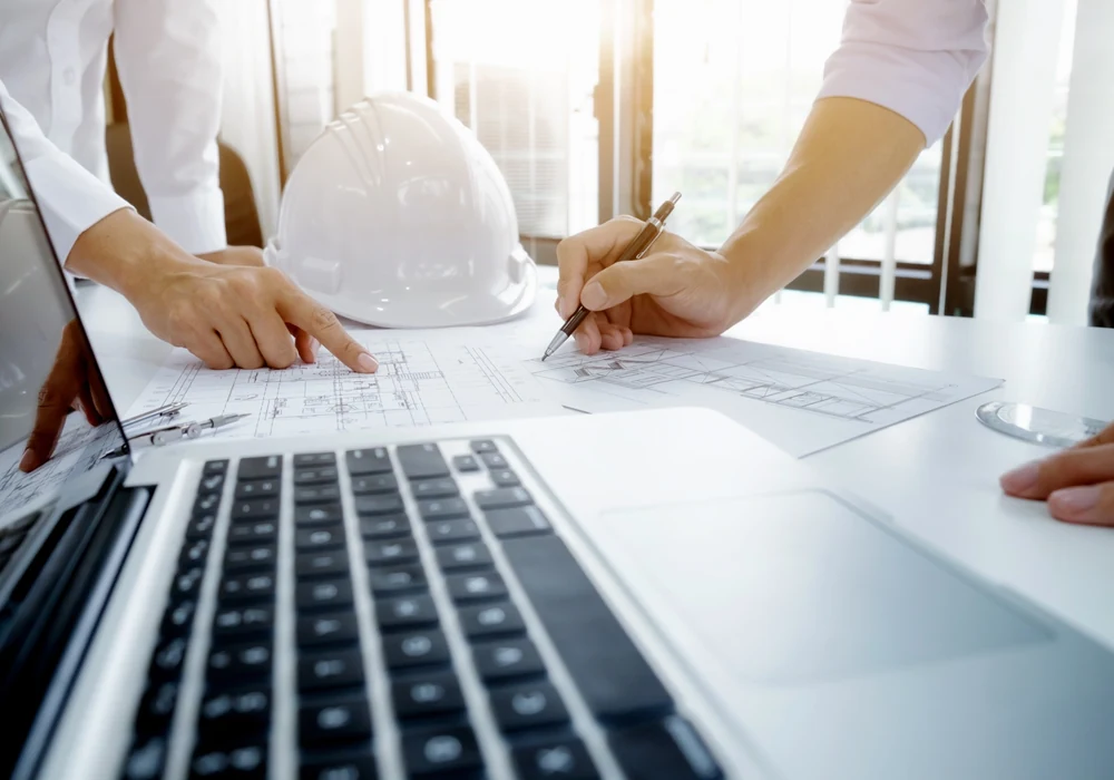 Engineering team reviewing construction drawings and project information