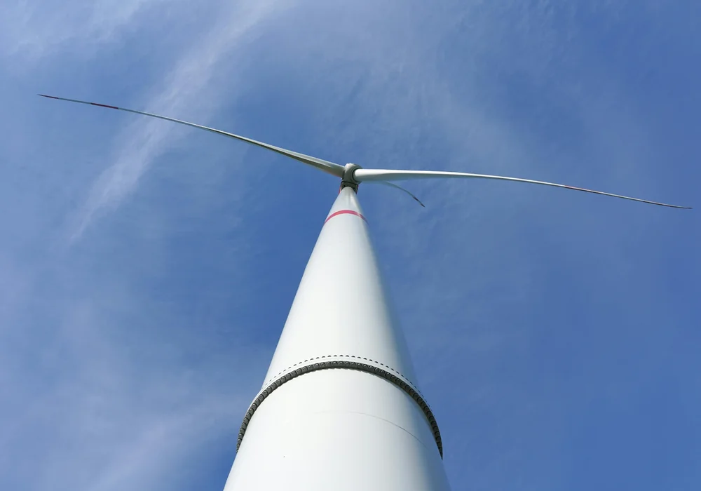 Wind turbine against blue sky